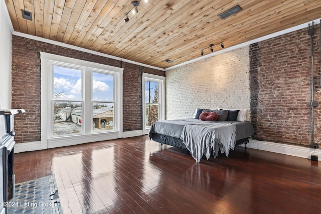 bedroom with crown molding, wooden ceiling, brick wall, and hardwood / wood-style flooring