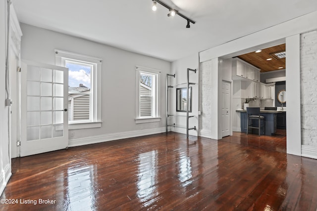 unfurnished living room featuring dark wood-type flooring