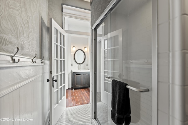 bathroom with vanity, hardwood / wood-style flooring, and walk in shower