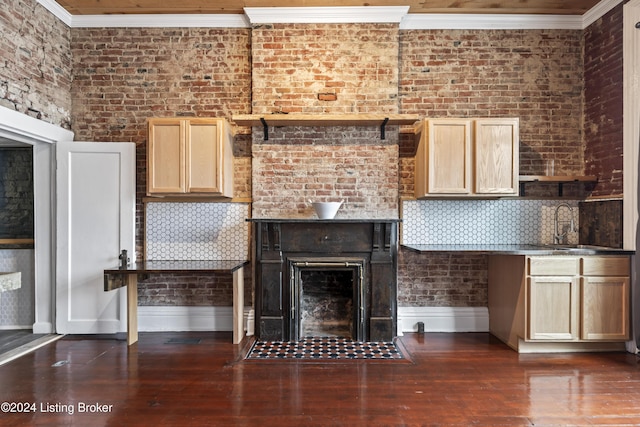 unfurnished living room with brick wall, dark hardwood / wood-style floors, and ornamental molding