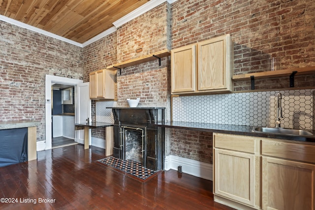 kitchen featuring backsplash, dark wood-type flooring, sink, crown molding, and light brown cabinetry