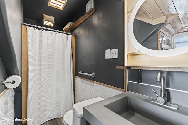 bathroom with sink, hardwood / wood-style floors, and toilet