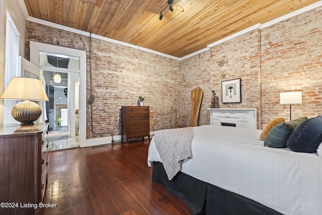 bedroom with dark hardwood / wood-style flooring, wooden ceiling, crown molding, and brick wall