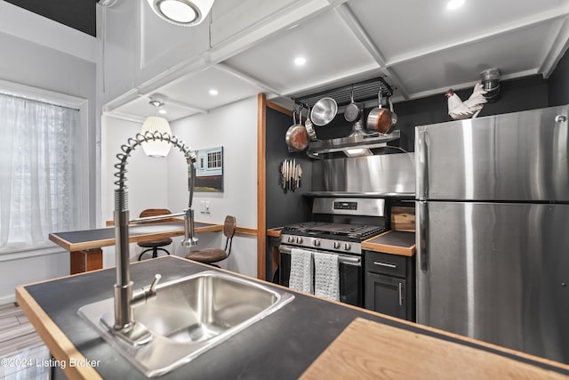 kitchen with stainless steel appliances, hardwood / wood-style flooring, coffered ceiling, and exhaust hood