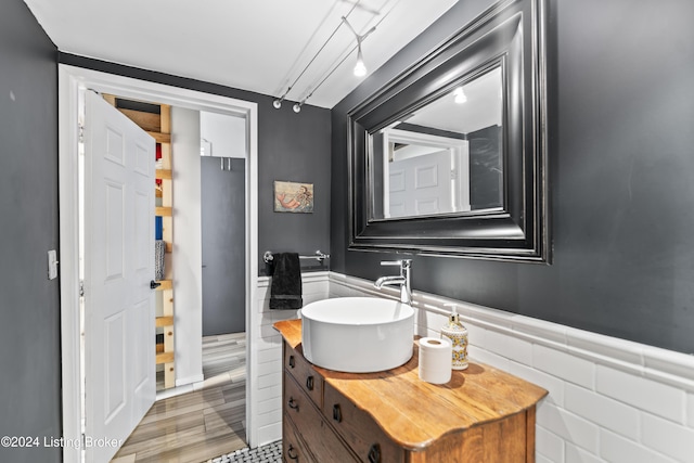 bathroom with vanity and tile walls