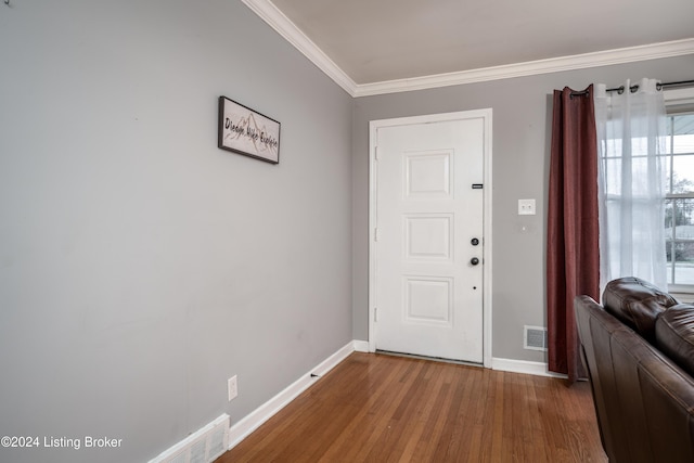 entrance foyer featuring crown molding and wood-type flooring