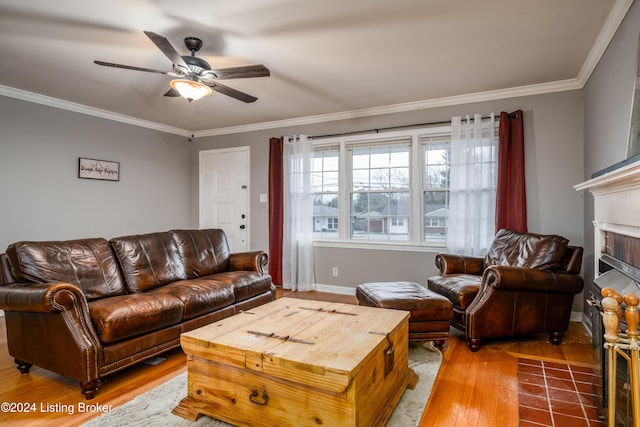 living room with hardwood / wood-style flooring, ceiling fan, and ornamental molding