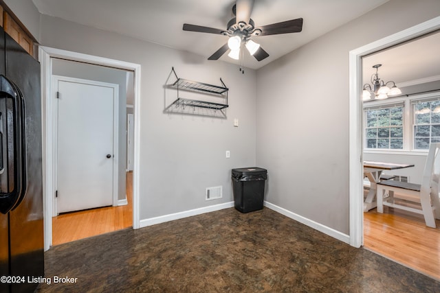 interior space featuring ceiling fan with notable chandelier, dark hardwood / wood-style flooring, and ornamental molding