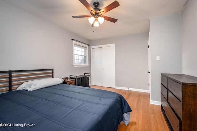 bedroom with ceiling fan, a closet, and light hardwood / wood-style flooring