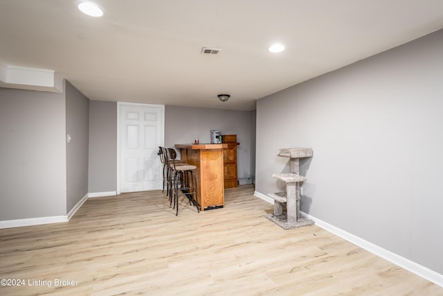 bar with light wood-type flooring