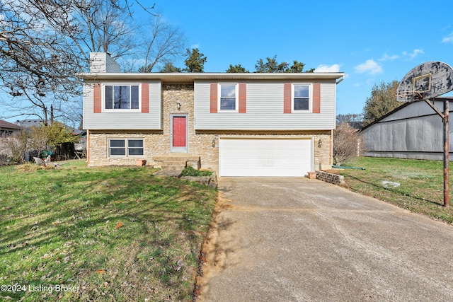 split foyer home with a garage and a front lawn