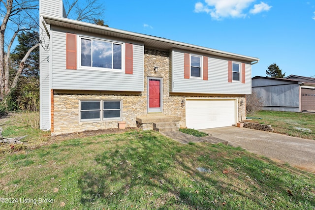 raised ranch with a front yard and a garage