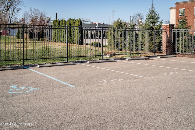 view of vehicle parking featuring a lawn