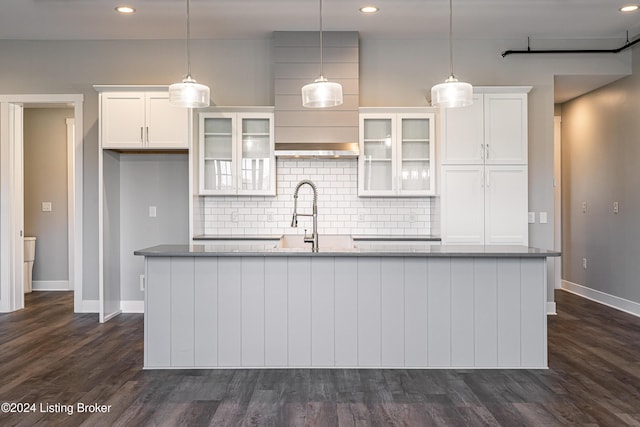 kitchen featuring dark wood-type flooring, white cabinets, and pendant lighting