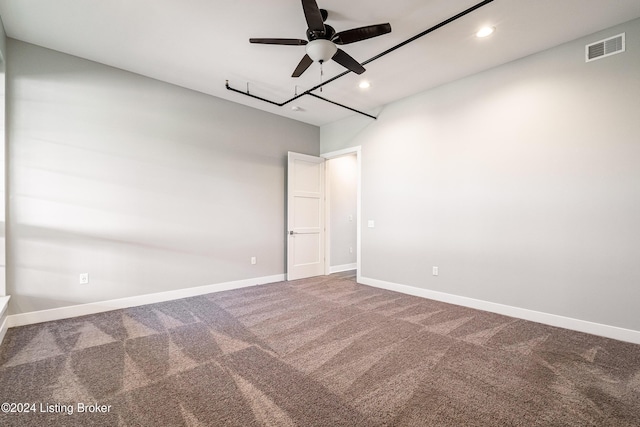 spare room with carpet and ceiling fan