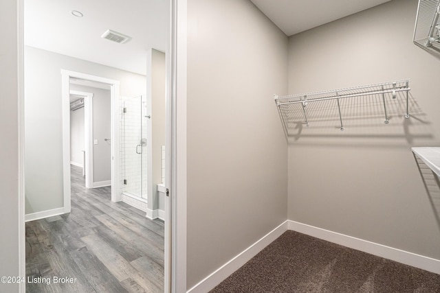 spacious closet with hardwood / wood-style floors