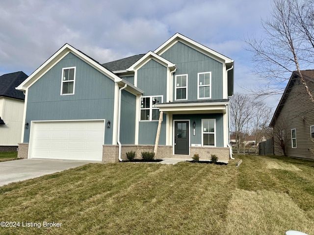 view of front of house with a front yard and a garage