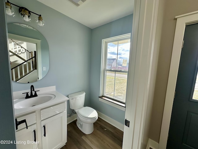 bathroom featuring vanity, toilet, and wood-type flooring