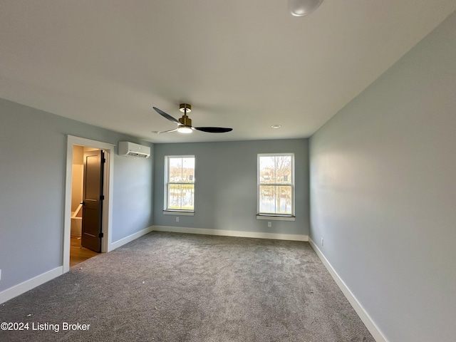 unfurnished bedroom featuring carpet, ceiling fan, and a wall mounted AC