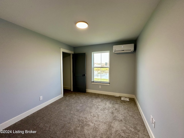 unfurnished bedroom with carpet flooring and a wall unit AC