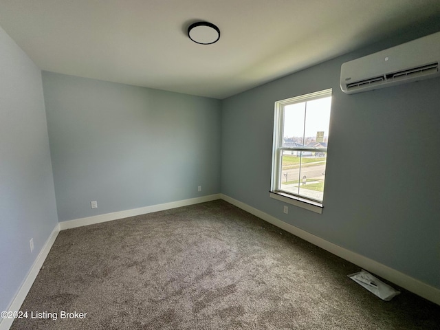 empty room with carpet flooring and a wall mounted air conditioner