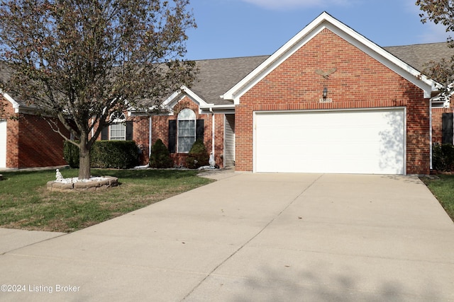 view of front of home featuring a front yard and a garage