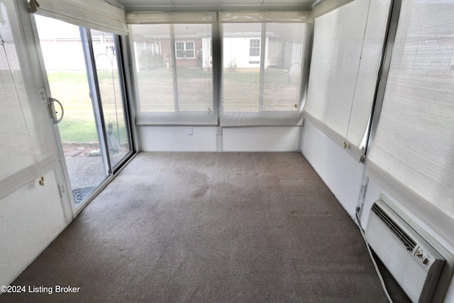 unfurnished sunroom with a wall mounted air conditioner