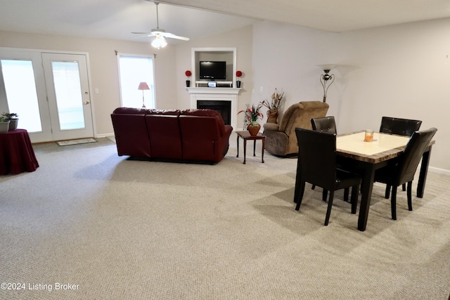 carpeted dining area featuring ceiling fan