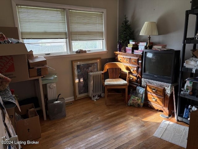 sitting room featuring radiator and light hardwood / wood-style flooring