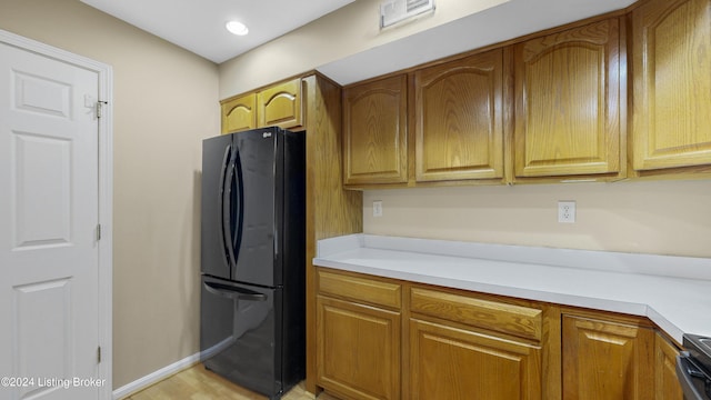 kitchen with black fridge and stainless steel range oven