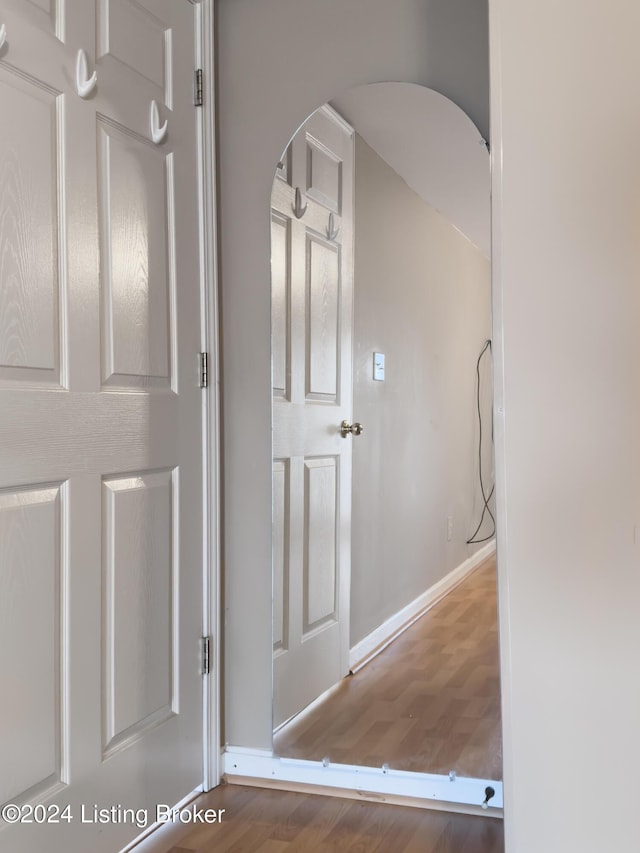 hall with hardwood / wood-style flooring