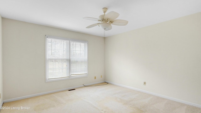 carpeted empty room featuring ceiling fan