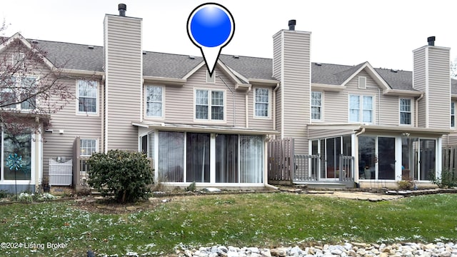 rear view of property with a sunroom