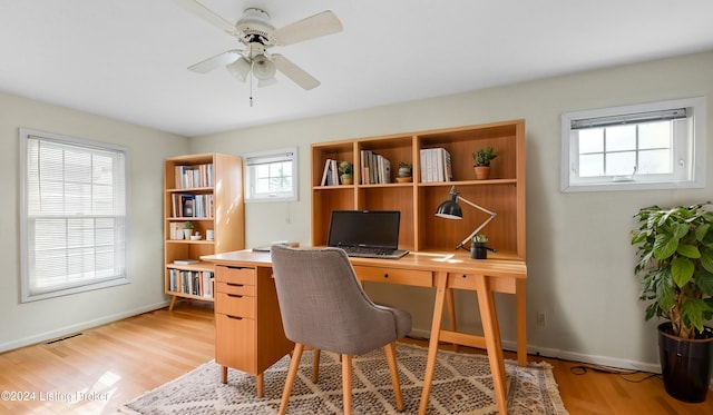 office area with light wood-type flooring and a healthy amount of sunlight