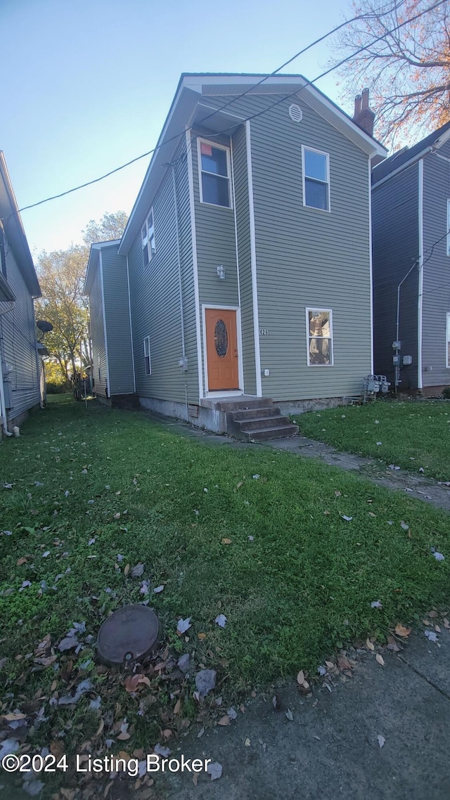 rear view of house with a yard