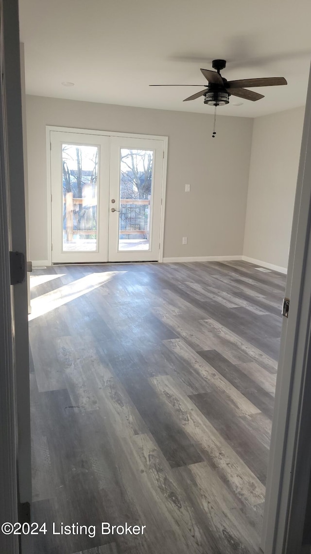 spare room with french doors, dark hardwood / wood-style floors, and ceiling fan