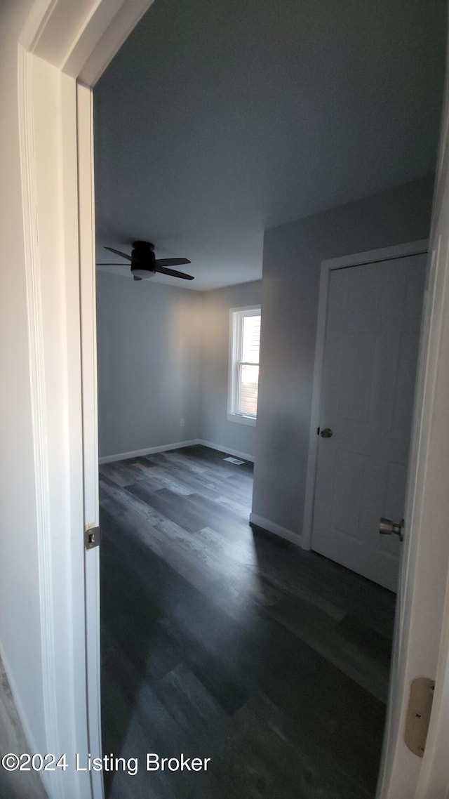 spare room featuring ceiling fan and dark hardwood / wood-style flooring