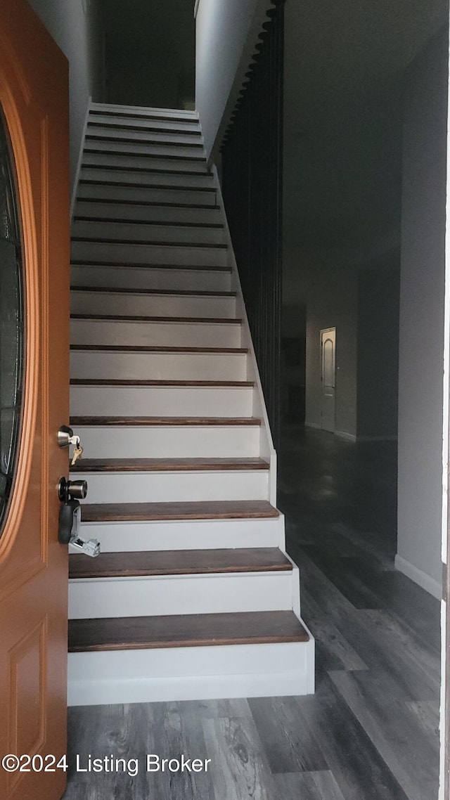 staircase featuring hardwood / wood-style flooring