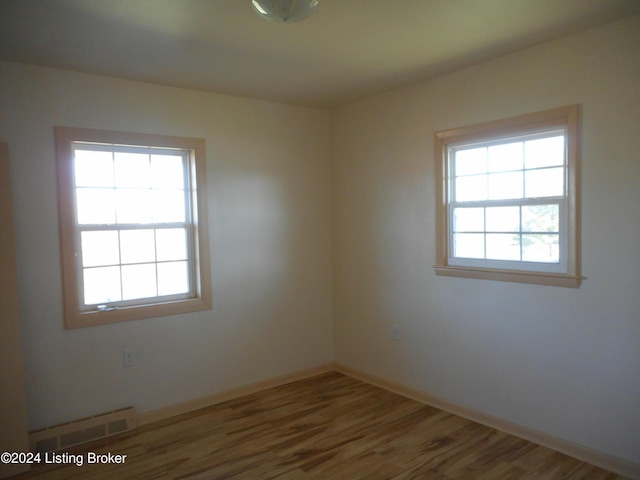 empty room featuring hardwood / wood-style floors and a wealth of natural light