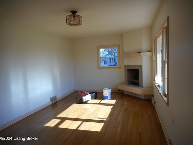 unfurnished living room with dark hardwood / wood-style floors