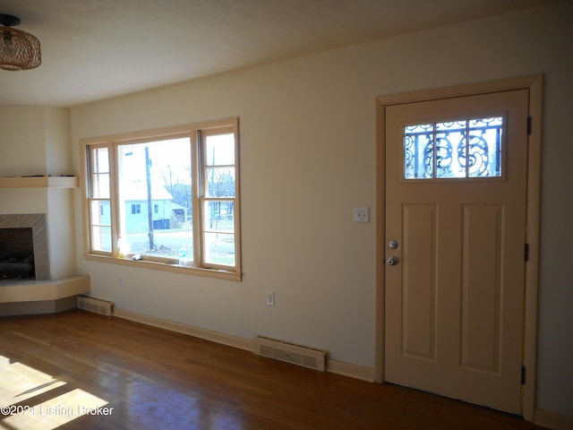 entryway with a fireplace and hardwood / wood-style floors