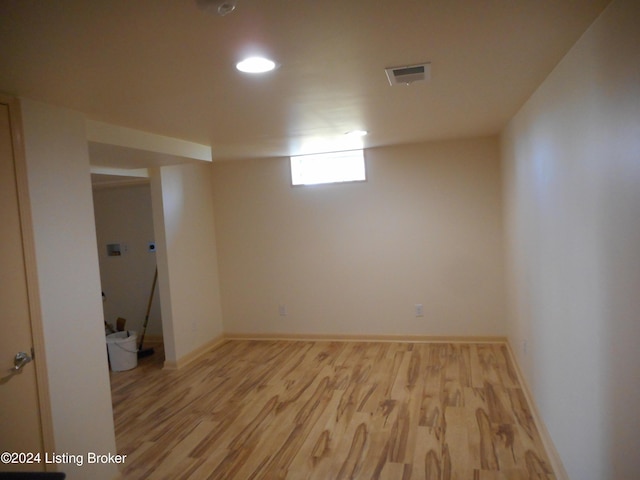 basement with light hardwood / wood-style floors