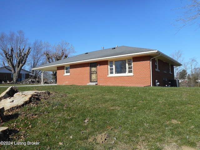 back of house with a lawn