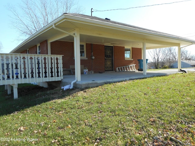 rear view of property with a lawn