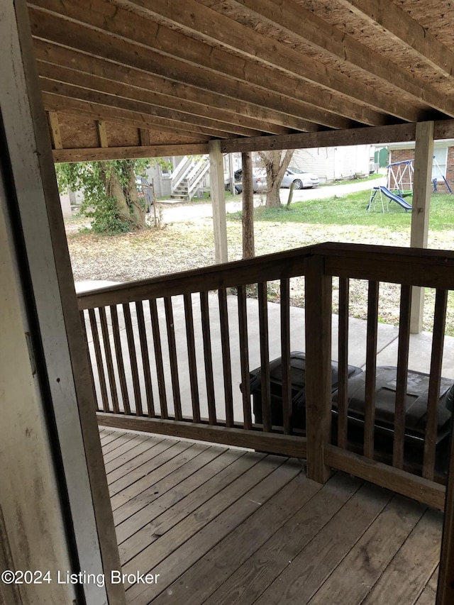 deck featuring stairs and a playground