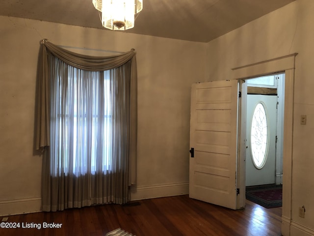 entryway with wood finished floors and baseboards