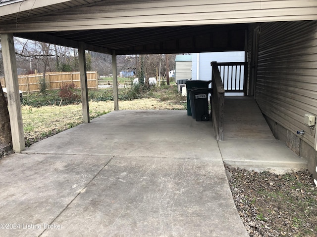 view of patio featuring fence and driveway