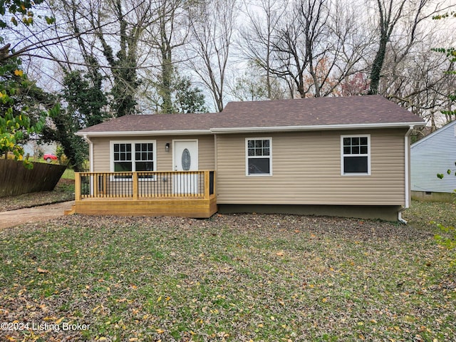 view of front of property featuring a front lawn and a deck