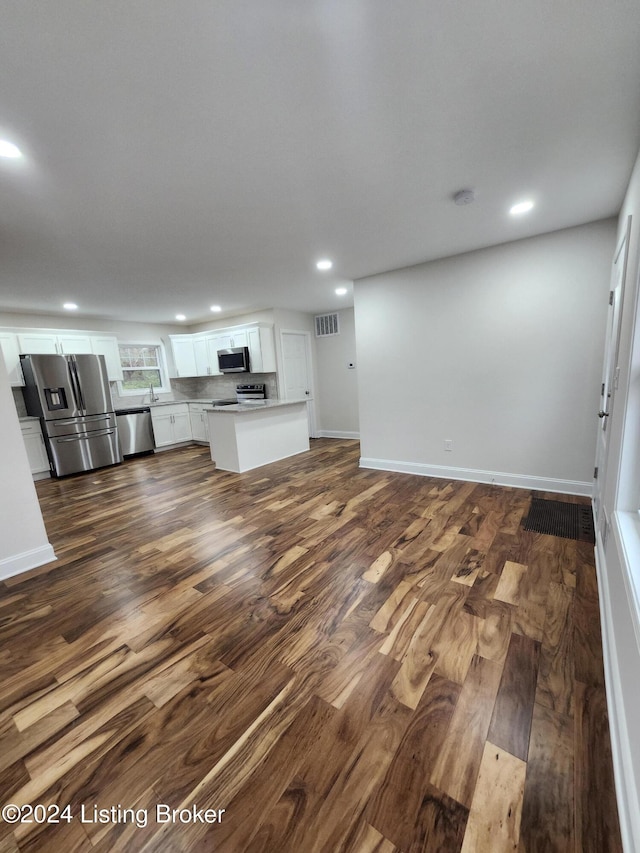 unfurnished living room with dark hardwood / wood-style flooring