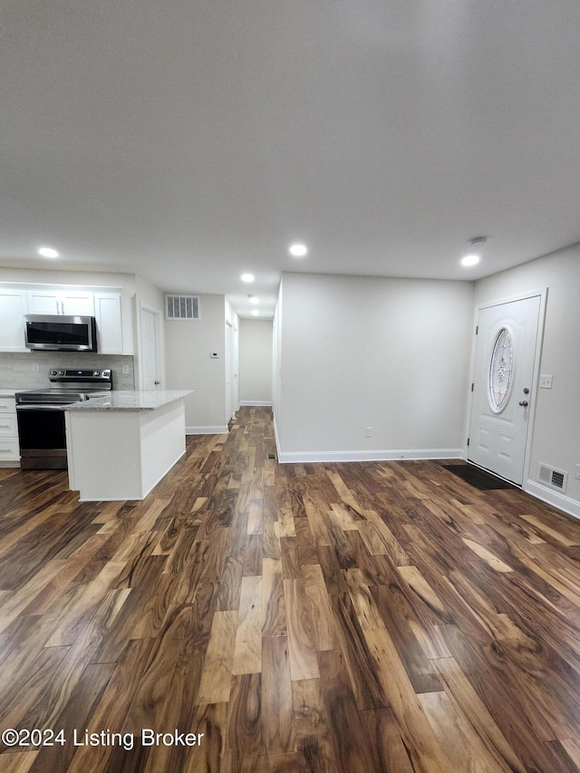 unfurnished living room featuring dark hardwood / wood-style flooring